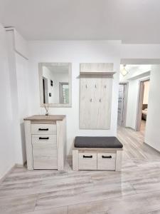 a white bathroom with a bench and a mirror at Ultracentral 4Bedroom with 2 Bathrooms Cozy Apartment in Suceava in Suceava