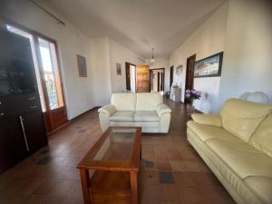 a living room with two couches and a coffee table at Sa domo manna in Porto Ottiolu