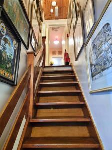 a staircase in a house with paintings on the walls at Centrally located in Canterbury with two bedrooms and a sofa bed in Canterbury