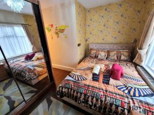 a bedroom with two beds and a mirror at Centrally located in Canterbury with two bedrooms and a sofa bed in Canterbury