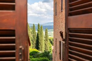 a view from a window of a building with trees at L'Olivazzo Apartment in Chiusi