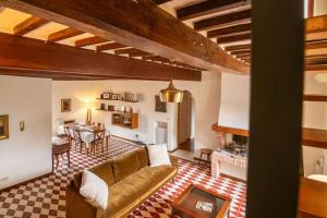 a living room with a couch and a table at L'Olivazzo Apartment in Chiusi