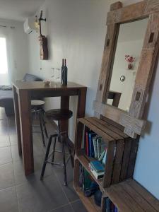 a room with a table and a mirror and a stool at Namastĕ in Sisco