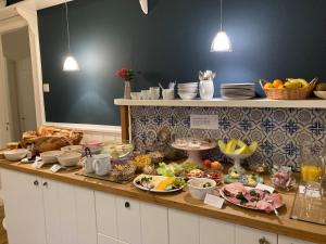 a buffet of food on a counter in a kitchen at Pension Hilligenlei Zi 01 EZ in Wyk auf Föhr