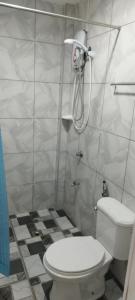 a bathroom with a toilet and a shower at Dumaguete divers rooms in Dauin +3 photos