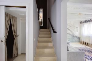 a staircase in a home with white walls and white floors at Maison sul Pozzo, Venicevillas in Venice +25 photos