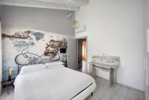 a bedroom with a white bed and a table at Maison sul Pozzo, Venicevillas in Venice