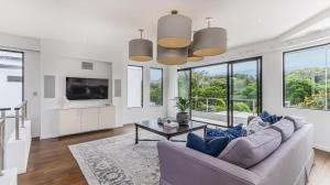 a living room with a couch and a table at Sandcastles in Casuarina