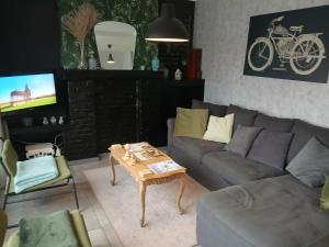 a living room with a couch and a coffee table at Vakantiehuis 2 Wheels 2 Relax in Wellen
