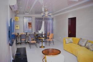 a living room with a couch and a table and chairs at Ken Koral Bed and Breakfast in Gaborone