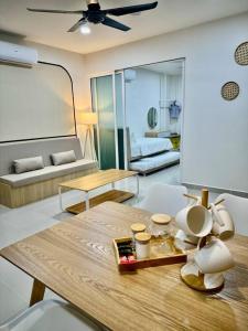 a living room with a table and a couch at The Shore Suite seaview balcony Free Wifi & Netflix in Kota Kinabalu
