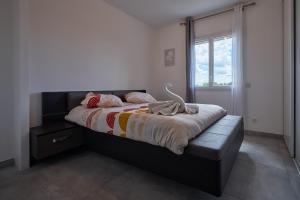a bedroom with a large bed with a window at charming villa with heated pool, 14 people, located in aureille, near les baux de provence, in the alpilles in Aureille +63 photos
