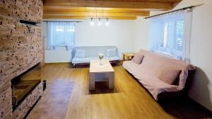 a living room with a couch and a fireplace at Chata Jožka in Vyšné Ružbachy