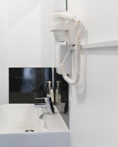 a white phone sitting on top of a sink at Oak Lodge in Welling +21 photos