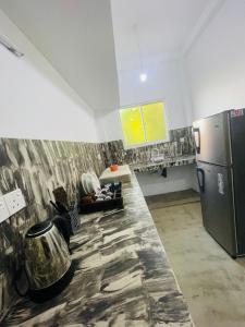 a kitchen with a refrigerator and a counter top at Villa bella vista ahangama in Ahangama
