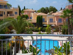 a view of the pool from the balcony of a resort at Resitour - Limnaria Gardens Apartments in Paphos +6 photos