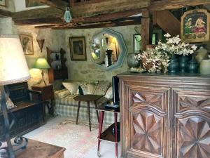 a living room with a large wooden cabinet with a mirror at Maison confortable à Bréhémont avec jardin paisible in Bréhémont +40 photos