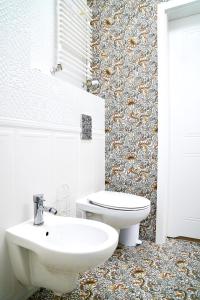 a bathroom with a toilet and a sink at Prince Apartment by Baltic Home in Świnoujście +13 photos