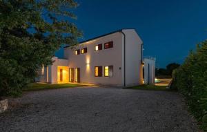 a white house at night with its lights on at Villa Dora in Central Istria kids friendly with private pool and playground for 10 persons in Svetvinčenat