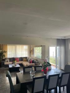 a living room with a couch and a table at Palio Luxury Apartment in Paleo Tsifliki