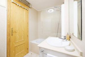 a bathroom with a sink and a toilet and a mirror at Villa Garmet Formigal in Formigal +17 photos