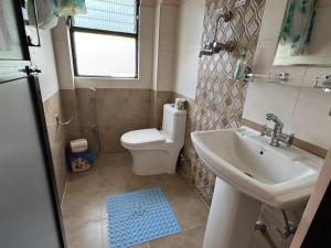 a bathroom with a toilet and a sink at Niru Yoga Homestay sound healing & hiking retreat in Bhaktapur +50 photos