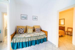 a bedroom with a bed with pillows on it at Vapelo a Marina di Campo in Marina di Campo