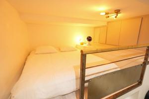 a small bedroom with a bed and a desk at Loft 2 BR Marais, Notre Dame AC by LCC Agency in Paris +23 photos