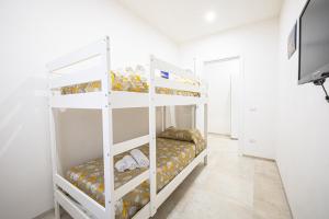 a white bunk bed in a white room at Villa Lumia in Tre Fontane +39 photos