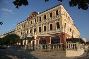 a large building with a balcony on a street at Duna Wellness Hotel in Baja +23 photos