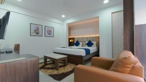 a hotel room with a bed and a couch at Magnus Aerith Studios Exclusive Residences in Pune