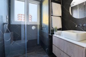 a bathroom with a sink and a shower at Pure Salt Residences in Playa de Palma +33 photos