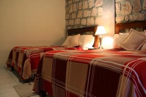 Giường trong phòng chung tại Plaza Magdalena Hotel