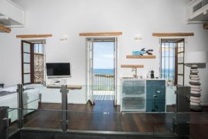 A television and/or entertainment centre at kito- transformed house on the water's edge