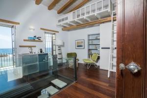 A seating area at kito- transformed house on the water's edge