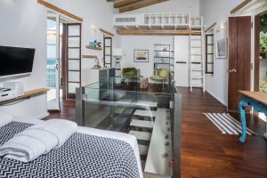 A television and/or entertainment centre at kito- transformed house on the water's edge