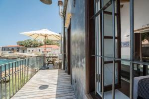 A balcony or terrace at kito- transformed house on the water's edge
