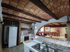 a kitchen with a sink and a living room at La Gran Casa de Galera in Galera