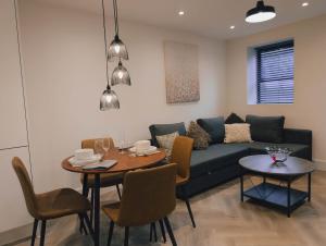 a living room with a couch and a table at Luxurious Apartment in St Albans in Saint Albans