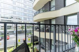 a balcony with a view of a building at Promienistych 2 in Kraków +2 photos