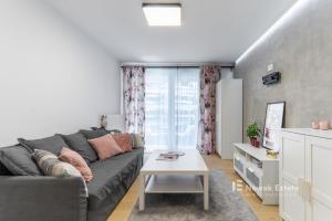 a living room with a couch and a table at Promienistych 2 in Kraków