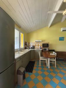 a kitchen with a table and a counter top at Habitation Pineau in Deshaies