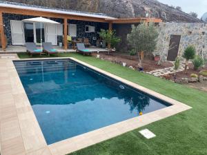 a swimming pool in the yard of a house at Casa La Jermosa in Pájara