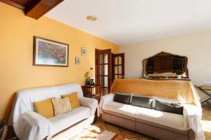 a living room with a couch and a bed at Les Corts De Biosca in Castelltallat +28 photos