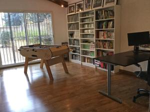 a living room with a pool table and a book shelf at Provencal farmhouse, pool, pool house, countryside Plan d’Orgon, Provence - 8 people in Cavaillon