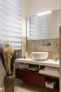 a bathroom with a sink and a mirror at Palazzo Cavour, 34 - Luxury Suite Cardo in Pavia +10 photos