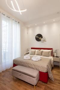 a bedroom with a large bed and a clock on the wall at Palazzo Cavour, 34 - Luxury Suite Cardo in Pavia