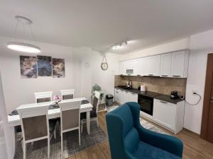 a kitchen and living room with a table and chairs at Ruža vetrova A1- duplex in Nova Varoš