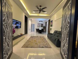 a living room with a couch and a table at Rumah Cemara by Impian Homestay in Sepang