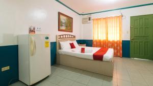 a small bedroom with a bed and a refrigerator at RedDoorz @ Orsu Hotel Angeles Pampanga in Angeles +28 photos